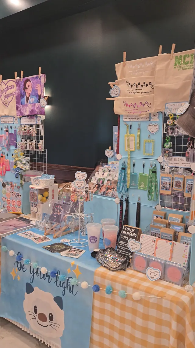 K-Pop merch booth with photocards and accessories